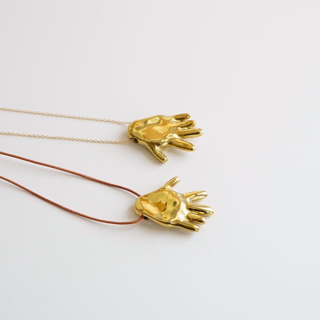 Gilded hand necklace