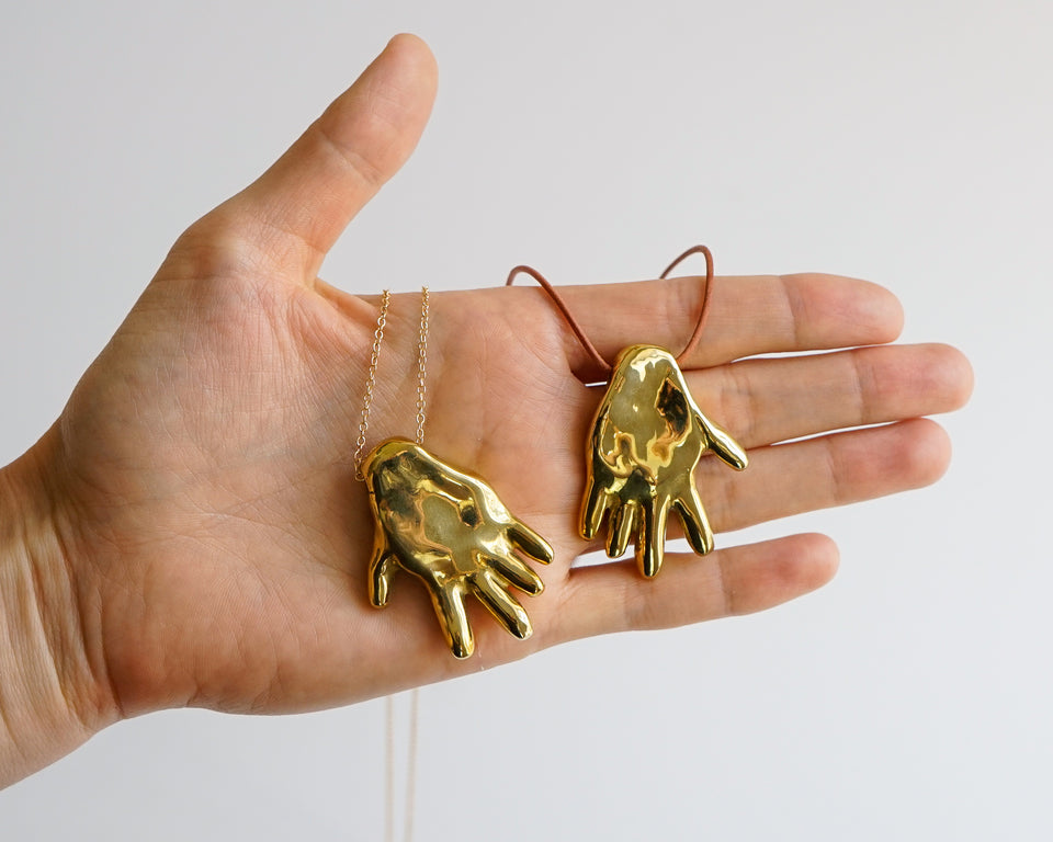 Gilded hand necklace