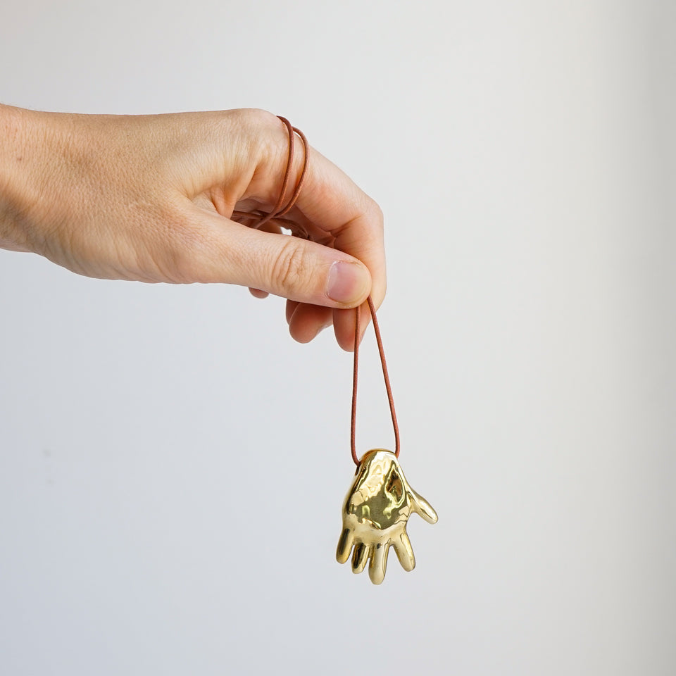 Gilded hand necklace